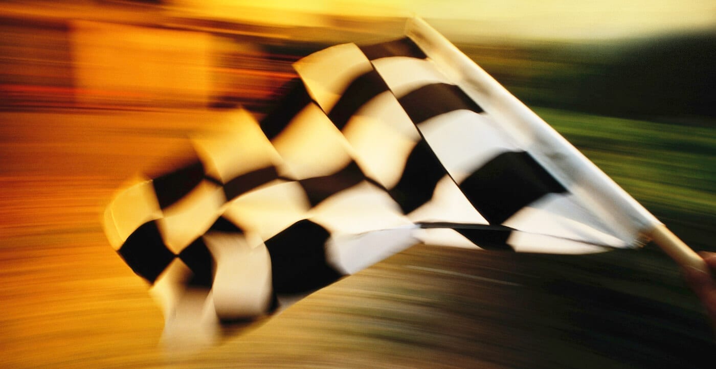 Checkered flag waving at a car race.