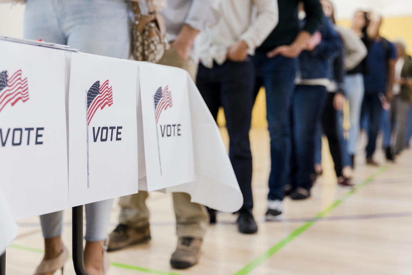 Low angle view of people lined up to vote Citizens in line to vote on election day