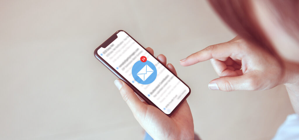 hand holding mobile phone that has just received an email