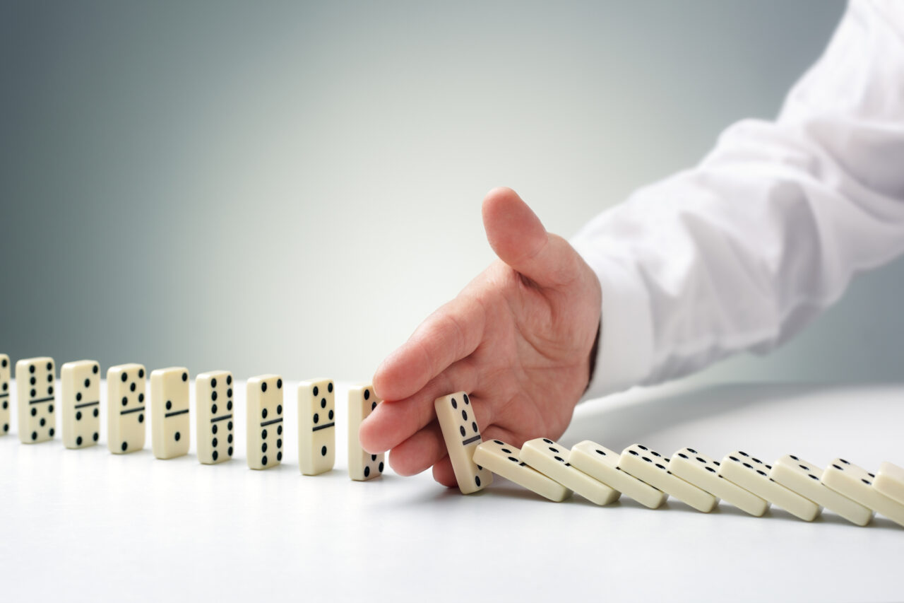 Stopping the domino effect concept for business solution, strategy and successful intervention
